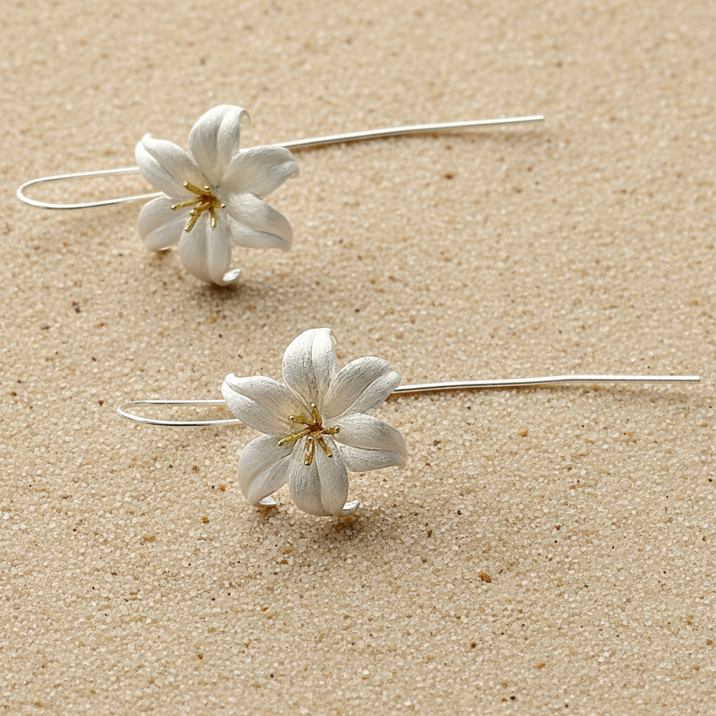 Silver lily earrings featuring intricate petal detailing and a polished metallic finish.