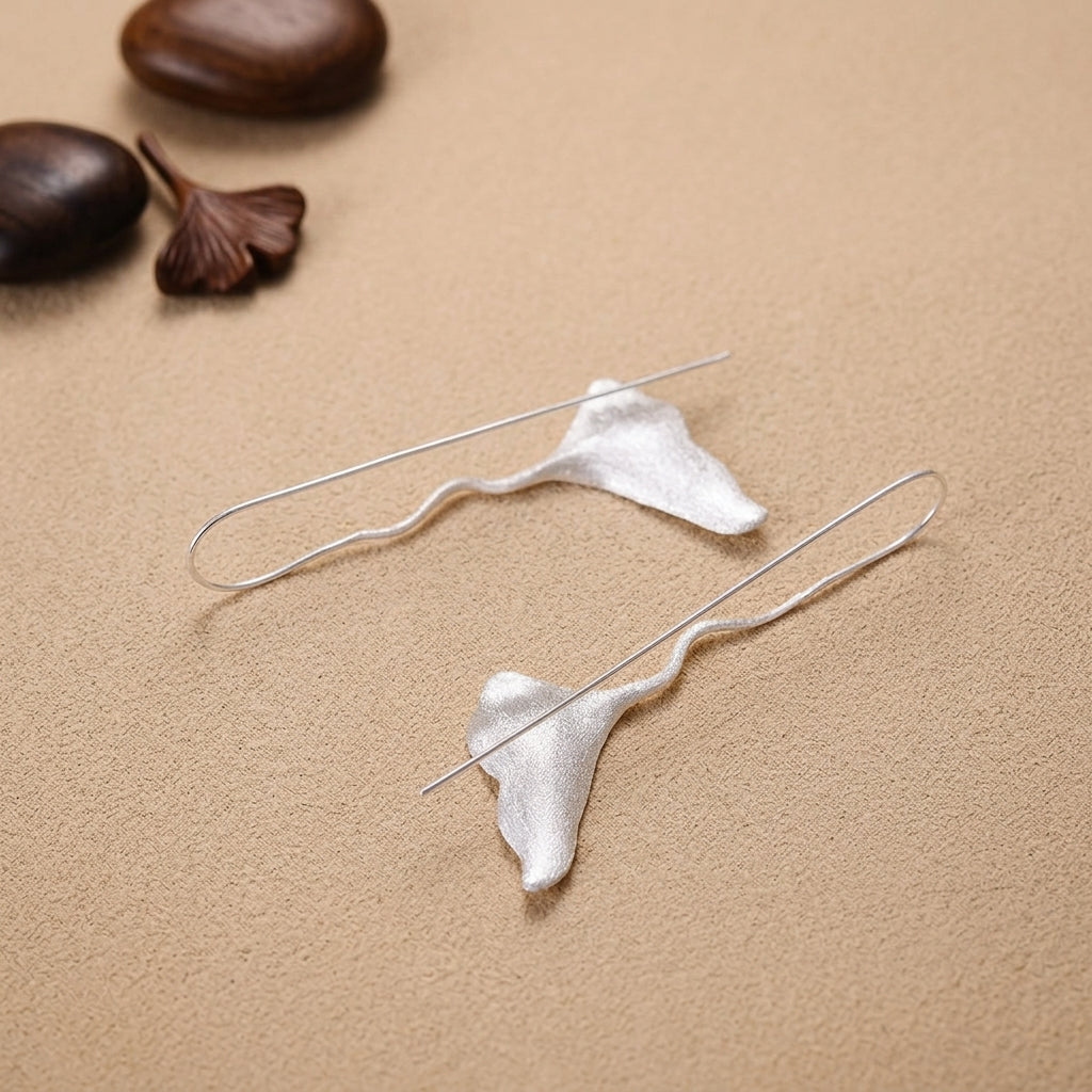Close-up of elegant 925 sterling silver Ginkgo biloba leaf dangle earrings for women