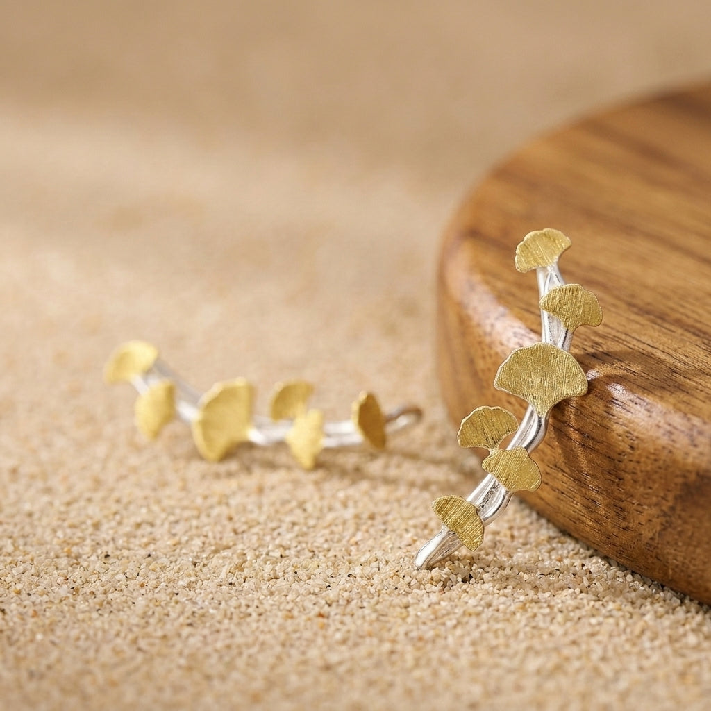 18kt gold plated ginkgo leaf climber earring with a polished finish and curved botanical design