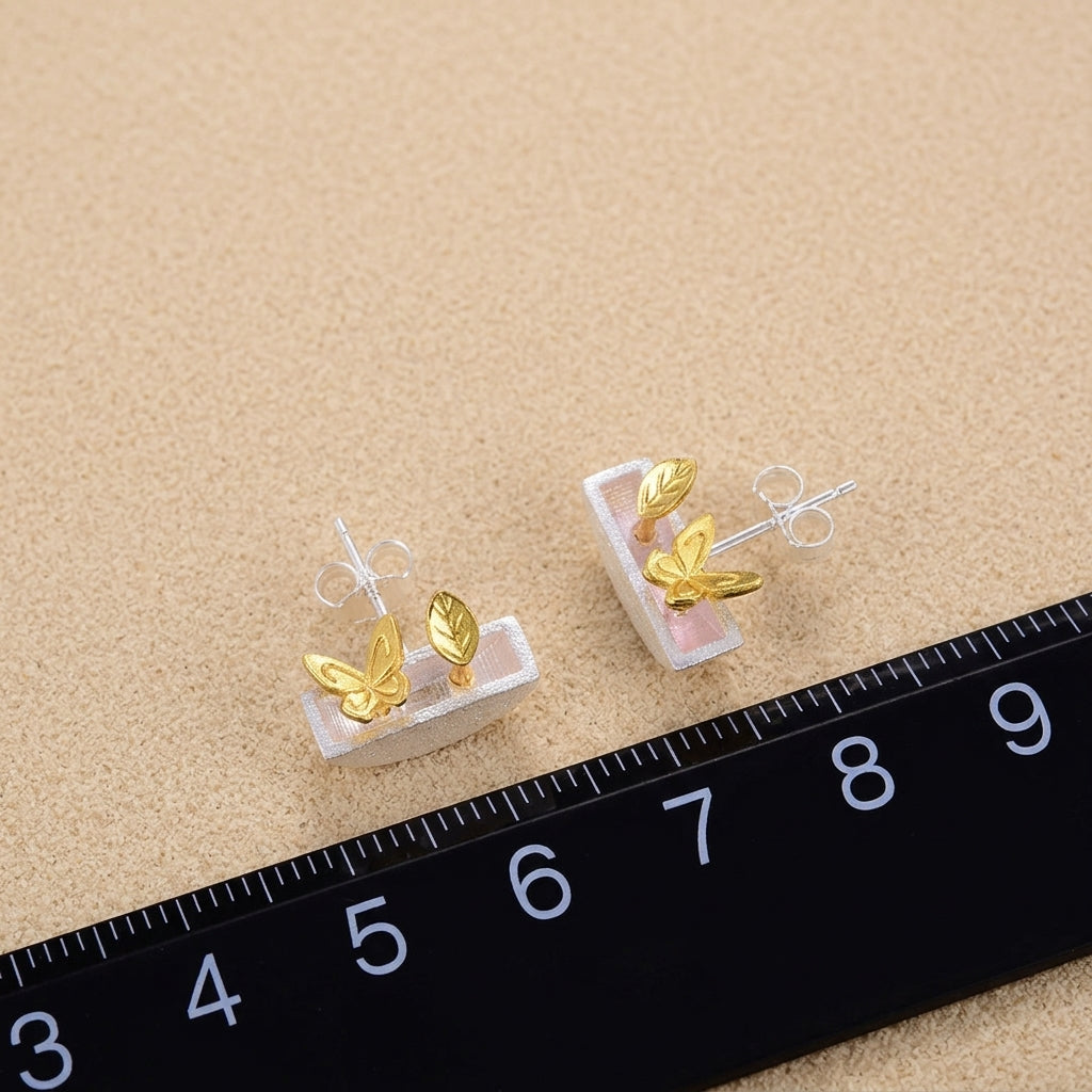 Handcrafted sterling silver plant pot earrings with gold accents, the perfect nature-inspired gift for plant lovers