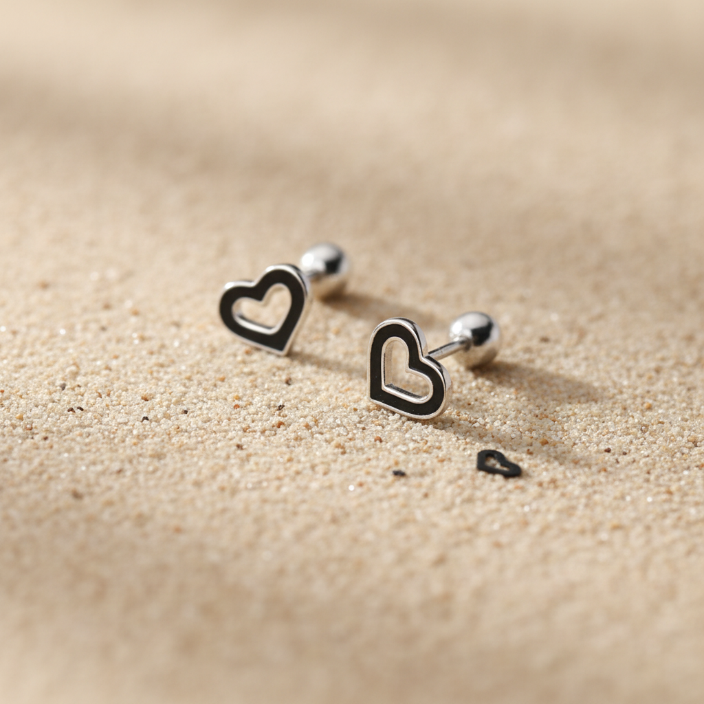 Sterling Silver heart earrings showing the threaded screw back for extra security and comfort.