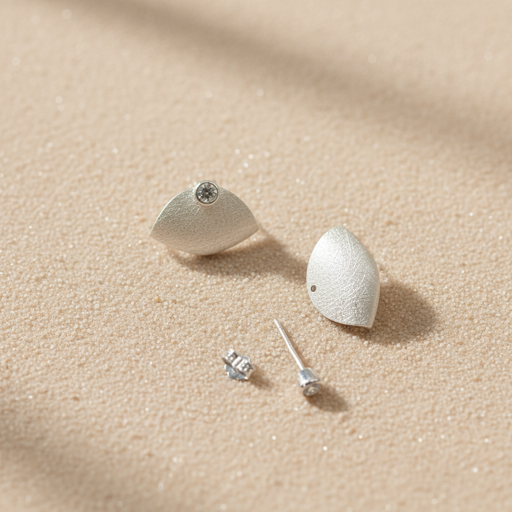 Close-up view of cute minimalist handbag studs in 925 sterling silver