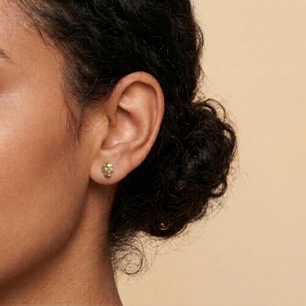 Birthday gift for her: a dainty gold skull stud earring for a minimalist ear piercing
