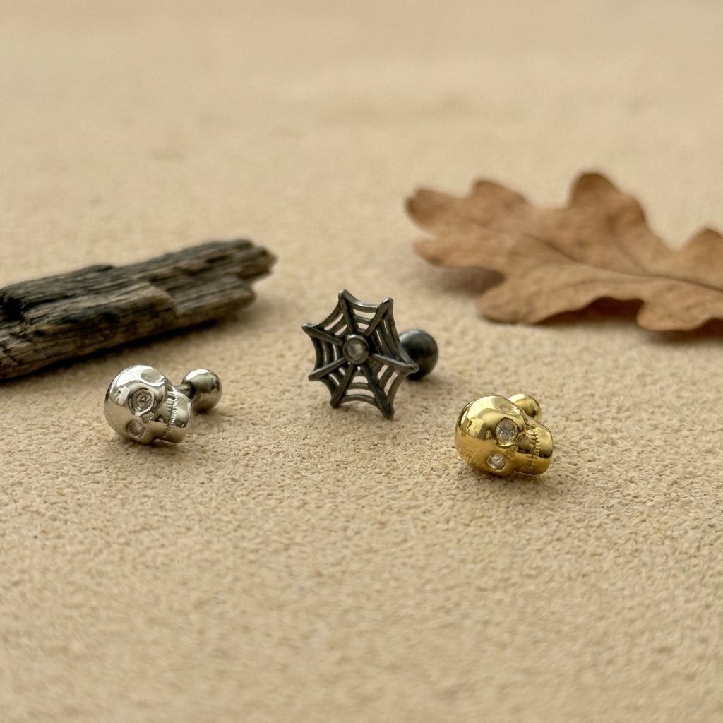 Juweries Salem mini stud trio, gold skull, silver skull, and black spiderweb studs