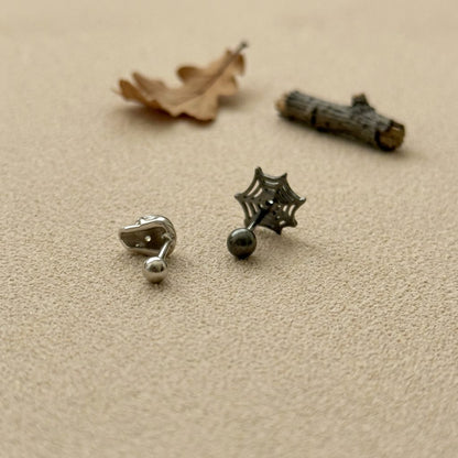 Detailed skull charm and spiderweb charm cartilage earrings with cubic zirconia stone