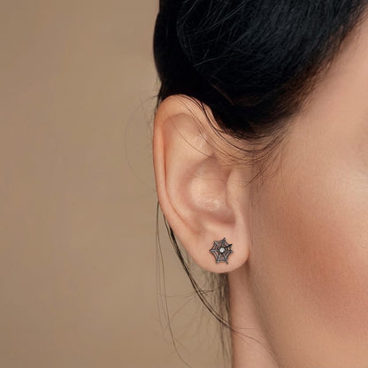 Black spiderweb cartilage stud earring with a sparkling cubic zirconia center stone