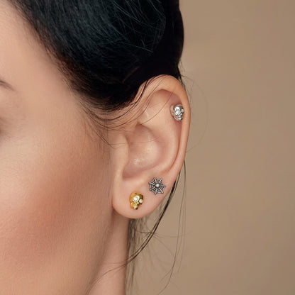 Unique gift for the goth lover in your life: skull and spiderweb cartilage stud set