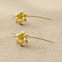 18kt Gold-Plated lily earrings featuring intricate petal detailing and a polished metallic finish.