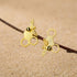 18kt gold plated bee earrings featuring a realistic honey bee perched on a textured honeycomb geometric design