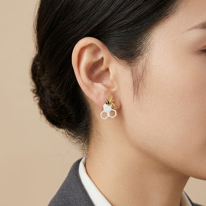 Honeycomb and bee stud earrings in polished 925 sterling silver with a detailed bumble bee on a hexagonal comb