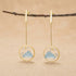 18kt gold-plated sterling silver circular dangle earrings featuring a delicate bird on a branch with a scenic mountain backdrop
