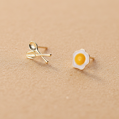 Sterling silver fried egg and cutlery stud earrings with 18k gold plating and white enamel.