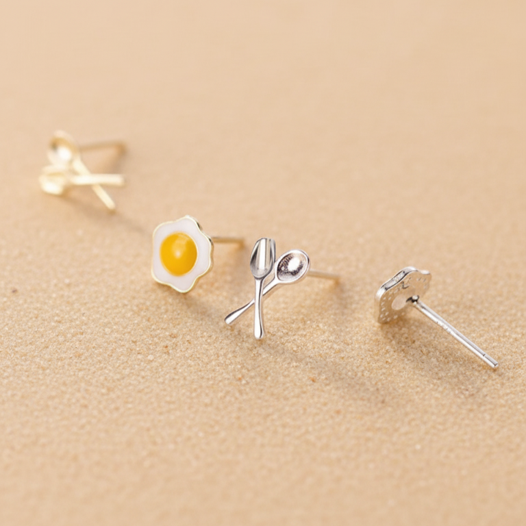 Playful gift for foodies: sterling silver and 18k gold breakfast stud earrings with a tiny egg and cutlery.