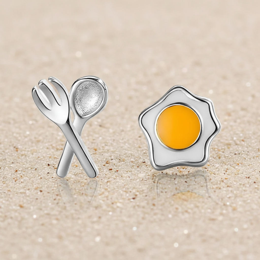 Sterling silver fried egg and cutlery stud earrings with 18k gold plating and white enamel.