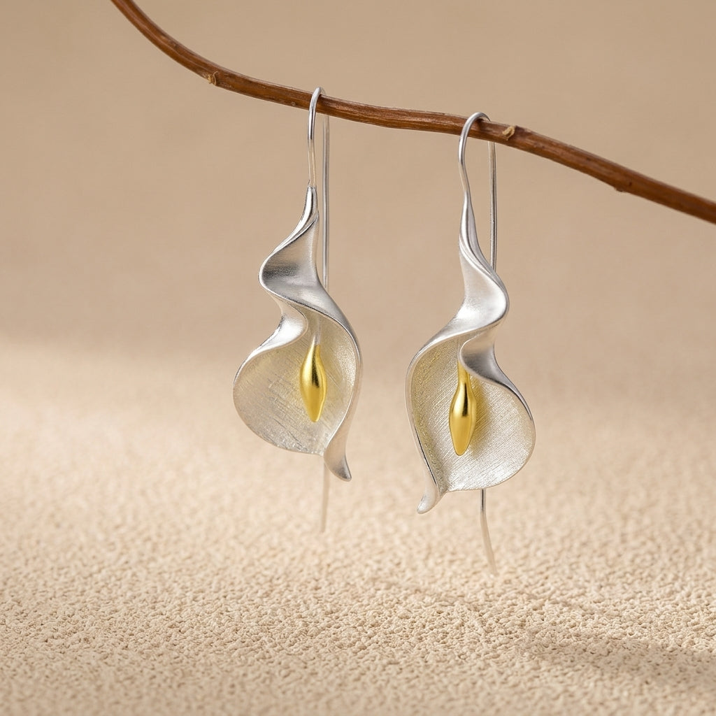 Handcrafted gold vermeil Calla Lily earrings with a fine silver base, showcasing a polished botanical drop design.