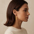 Elegant bridal Calla Lily jewelry, gold floral dangles perfect for weddings, anniversaries, or spring formal wear.