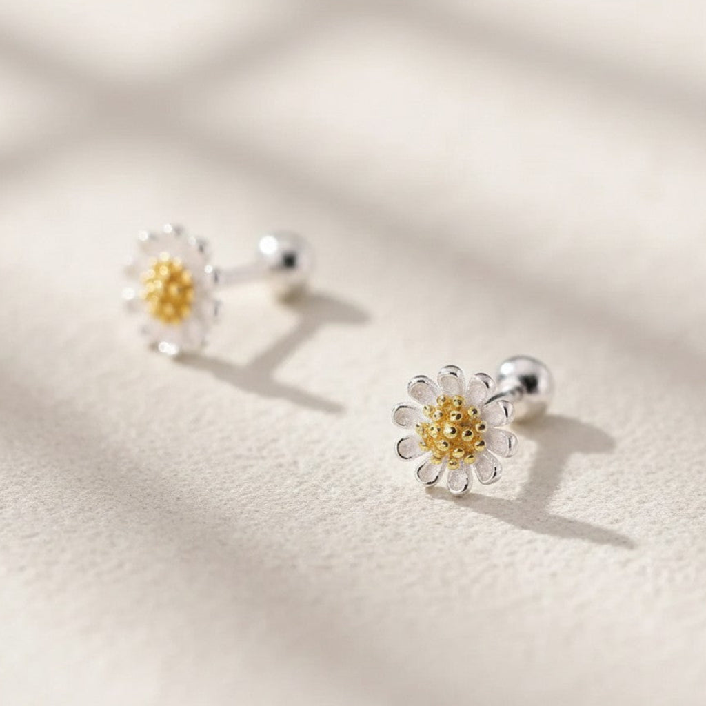 Pair of sterling silver mini daisy stud earrings with gold plating center detailing