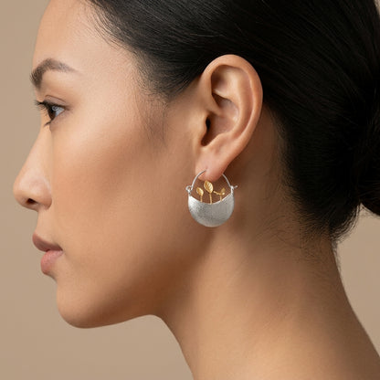 gold-plated floral hoop earrings, showcasing a boho-chic botanical accessory for spring and summer outfits.
