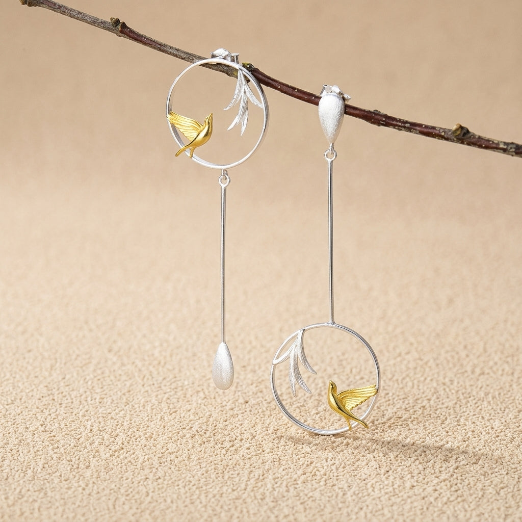 925 sterling silver hummingbird earrings highlighting the intricate wing details and high-shine gold-plated leaf accents