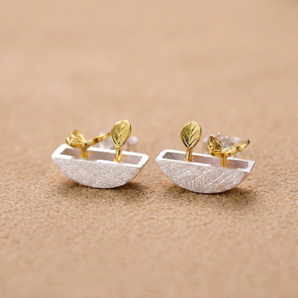Miniature sterling silver plant pot earrings with 18kt gold plated leaf accents and intricate garden-themed details
