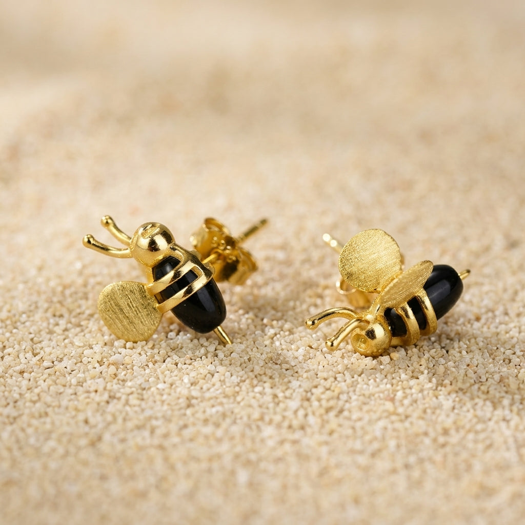 3D silver bee stud, highlighting the realistic depth and botanical jewelry style.