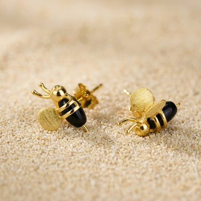 3D silver bee stud, highlighting the realistic depth and botanical jewelry style.