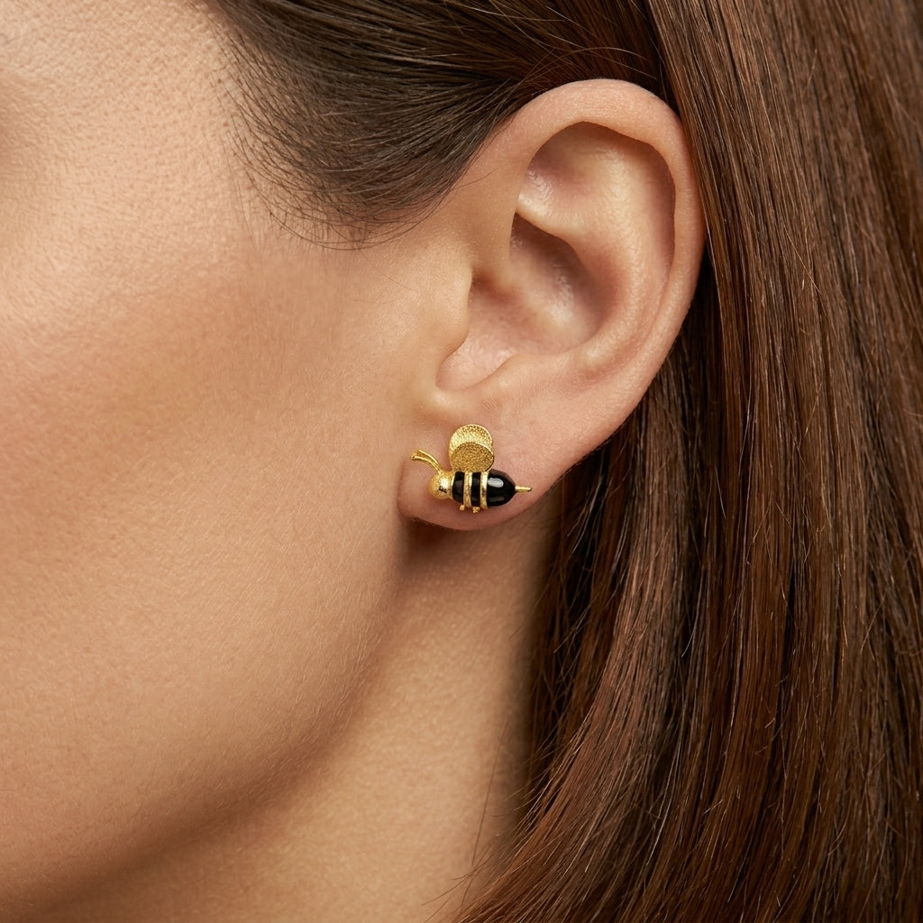 Model wearing a 3D 18kt gold plated bee earring to show the lifelike sculptural size and elegant fit