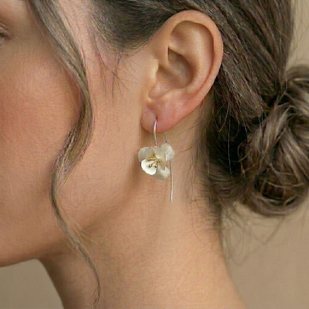 handcrafted sterling silver flower dangle earrings showing the delicate botanical petal texture