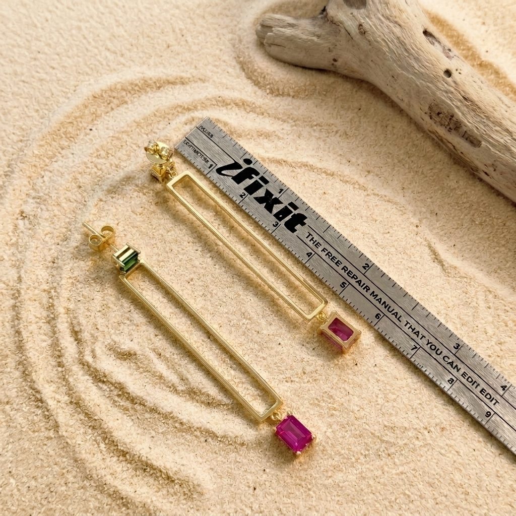 Solene gold-plated bar drop earrings shown next to a ruler for true-to-size scale