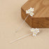 Sterling silver stud dangle earrings featuring three delicate flowers with gold plated accents in a vertical drop design.