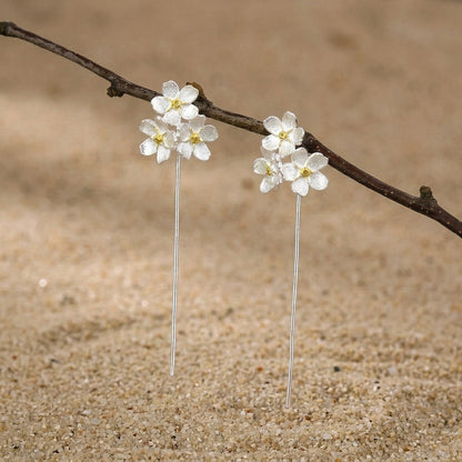 Elegant triple flower drop earrings for women, featuring dainty silver petals that sit as stud for a nature-inspired style